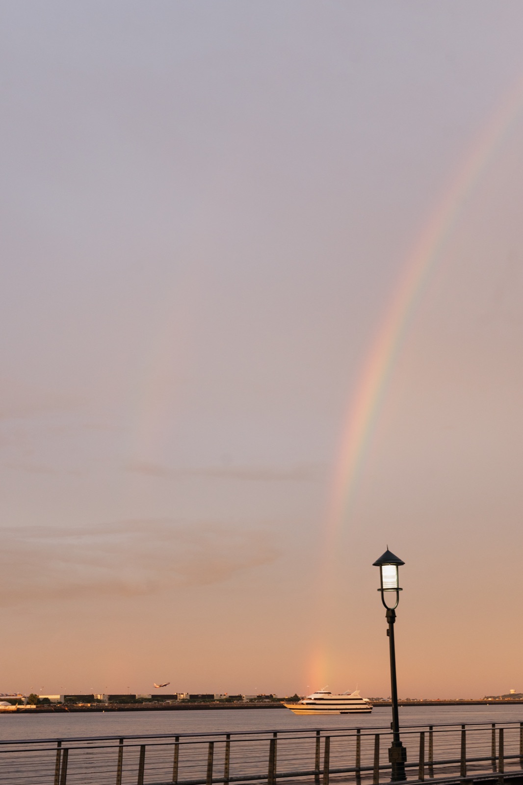 A rainbow over Boston Harbor in the evening light